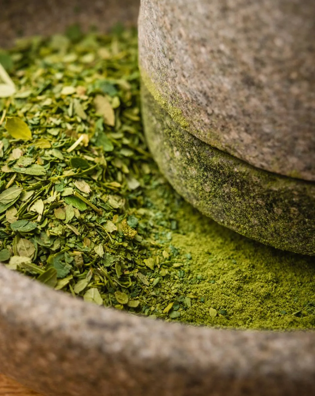 Dried moringa leaves and stone mill texture